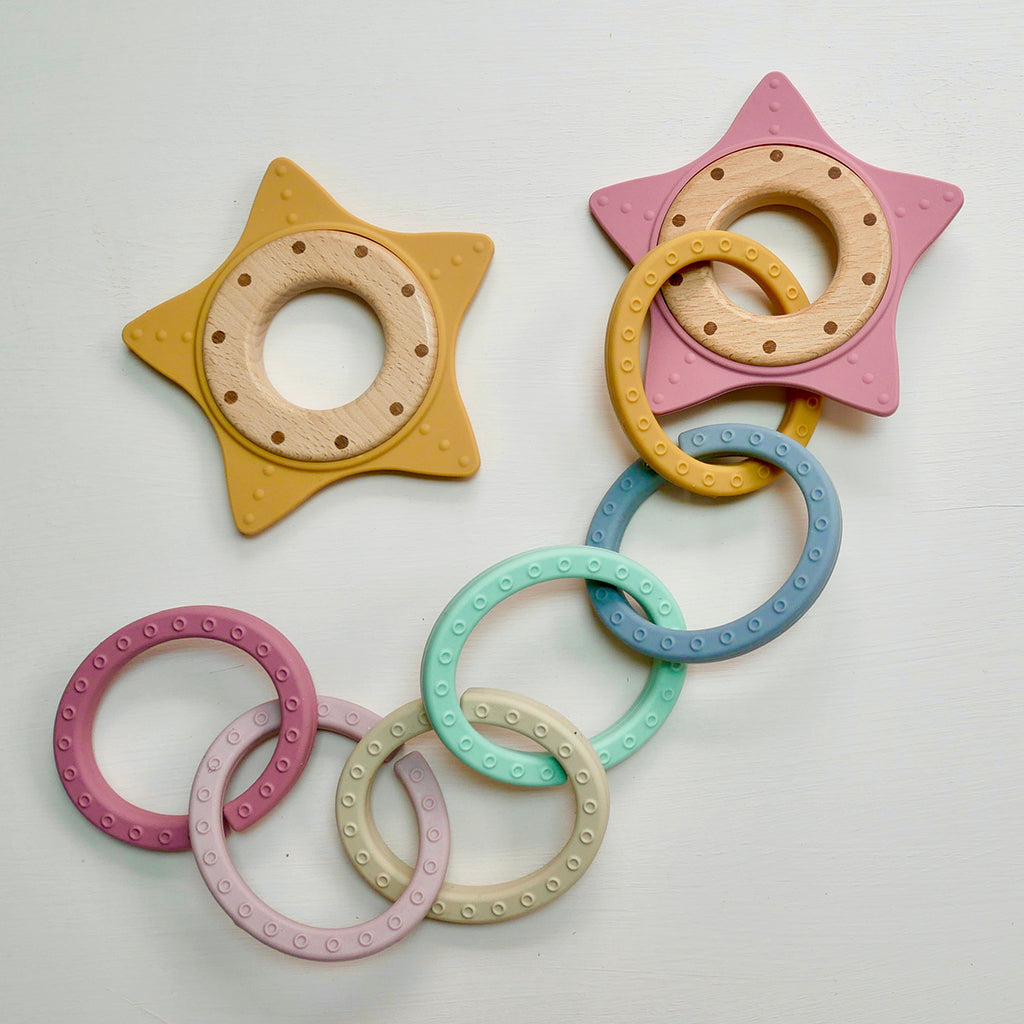 Super Star shaped silicone wood teether BPA-free in pink and mustard yellow with silicone Lovely Links pastel teething rings