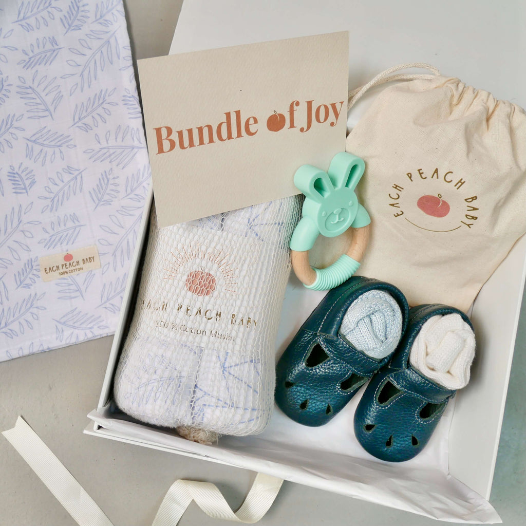 Newborn baby boy gift box set with leather baby shoes, organic cotton muslin cloths, bamboo baby socks and an eco-friendly BPA free baby teether