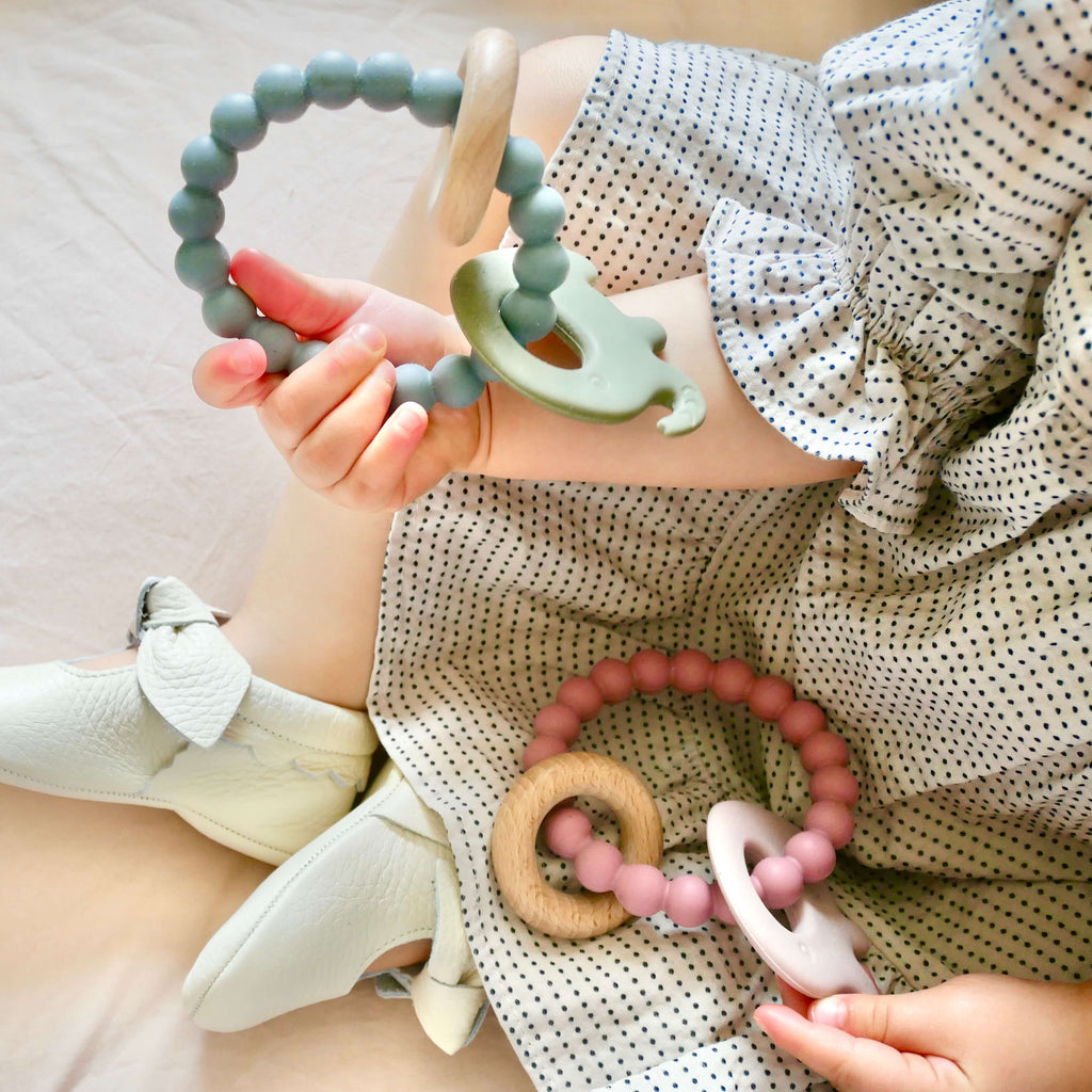 Elephant shaped baby teething toy with BPA silicone beads and beech wood ring in pink and green